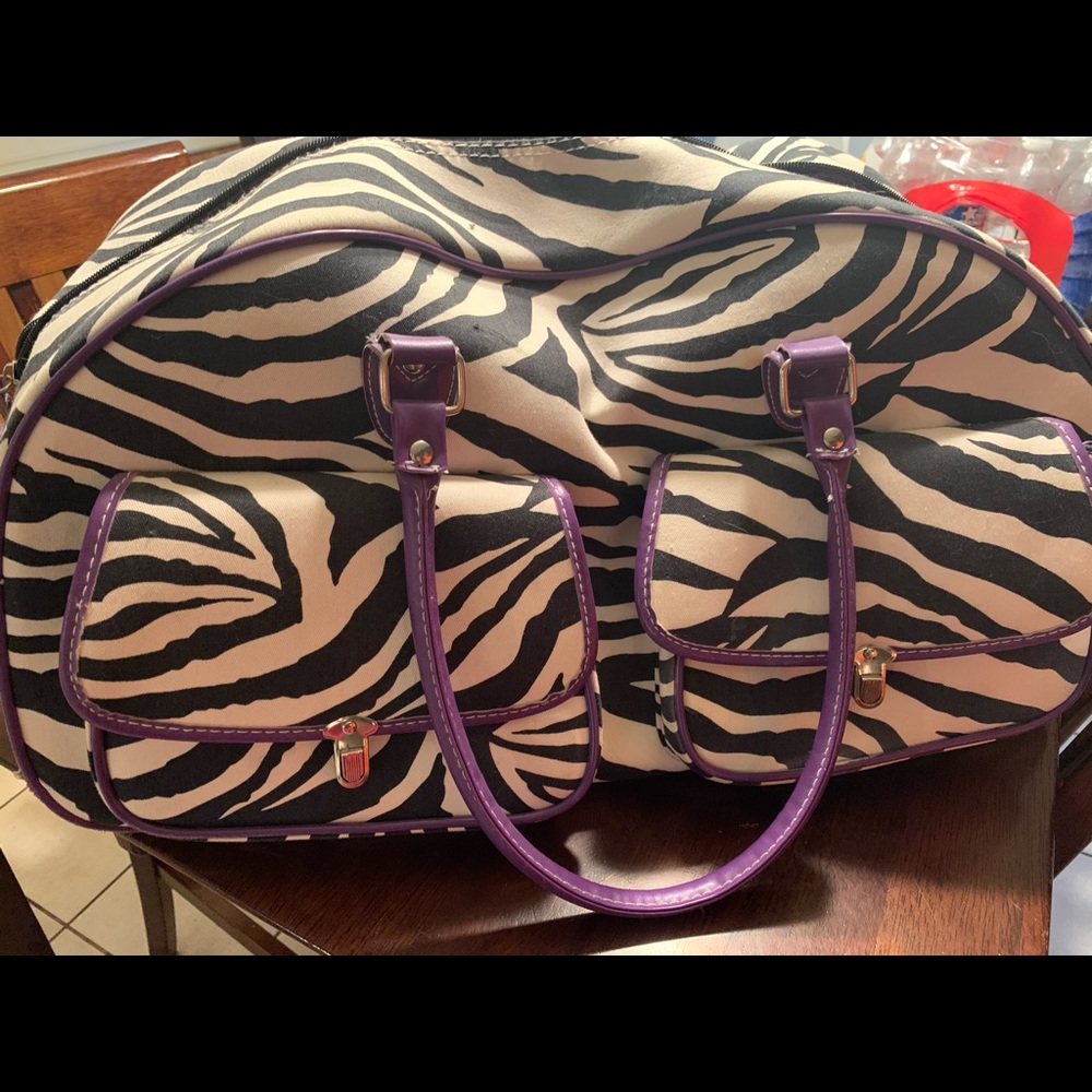 Zebra print roll suitcase